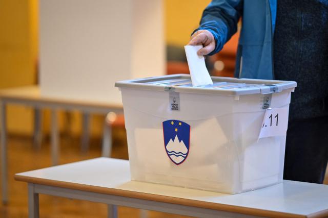 A voter casts their ballot during the general election in Radomlje on March 22, 2026. Slovenians are voting in tight parliamentary elections, with the conservatives of veteran politician Janez Jansa, an admirer of US President Donald Trump, eyeing a comeback. A Jansa return could see the ex-Yugoslav nation, a European Union member of two million people, take an illiberal turn again after four years of centre-left rule under liberal Prime Minister Robert Golob. (Photo by Jure Makovec / AFP)