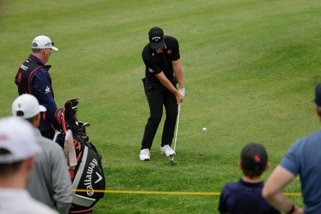 Legion XIII's US player Caleb Surratt chips a ball onto the 15th green on the fourth day of the LIV Golf South Africa tournament at The Club in Steyn City on March 22, 2026. (Photo by WIKUS DE WET / AFP)
