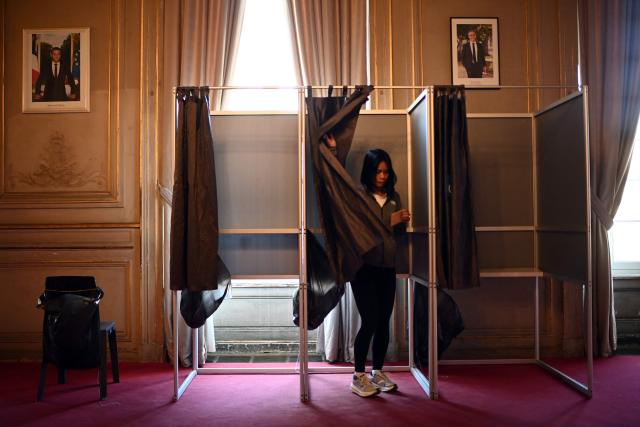 A citizen leaves the polling booth before voting during the second round of France's 2026 municipal elections in Bordeaux, southwestern France on March 22, 2026. (Photo by Christophe ARCHAMBAULT / AFP)