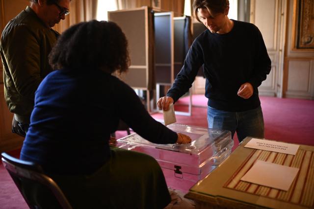 A citizen casts his ballot during the second round of France's 2026 municipal elections in Bordeaux, southwestern France on March 22, 2026. (Photo by Christophe ARCHAMBAULT / AFP)