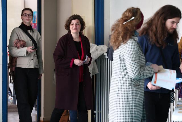 Strasbourg's incumbent mayor and Les Ecologistes candidate for re-election Jeanne Barseghian (2L) arrives at a polling station to vote during the second round of France's 2026 municipal elections in Strasbourg, eastern France on March 22, 2026. (Photo by FREDERICK FLORIN / AFP)
