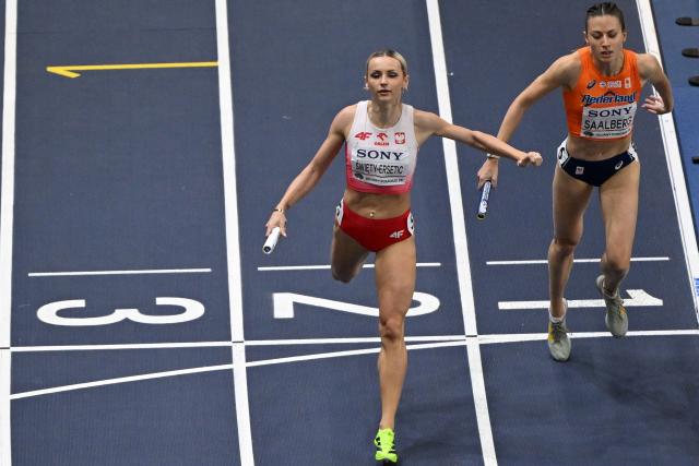 Poland's Justyna Swiety-Ersetic (L) reacts after finishing ahead of Netherlands' Eveline Saalberg to win the women's 4x400 metres relay heat 1 during the World Athletics Indoor Championships Kujawy Pomorze 2026 in Torun, Poland on March 22, 2026. (Photo by Andrej ISAKOVIC / AFP)
