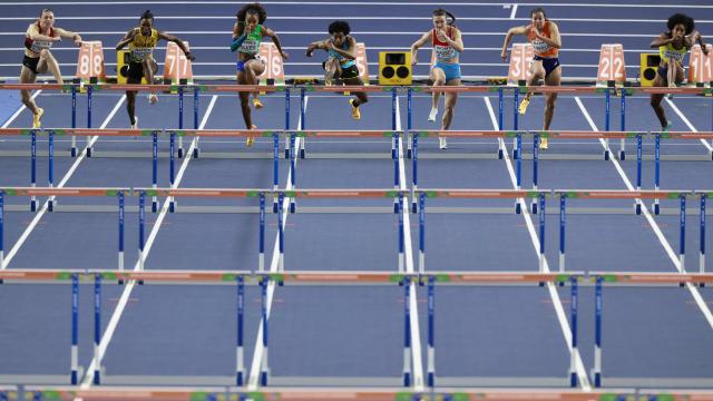 Denmark's Ida Beiter Bomme (L), Ghana's Evonne Britton, Brazil's Vitoria Alves, Bahamas' Devynne Charlton, Luxembourg's Victoria Rausch, Netherlands' Maayke Tjin-A-Lim and Colombia's Maria Fernanda Murillo compete in the women's 60 metres hurdles heat 4 during the World Athletics Indoor Championships Kujawy Pomorze 2026 in Torun, Poland on March 22, 2026. (Photo by Wojtek RADWANSKI / AFP)