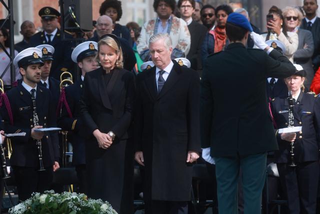 Belgium's King Philippe (C-R) and Queen Mathilde (C-L) attend a commemoration ceremony for the March 2016 terror attacks at the memorial monument on Rue de la Loi (Wetstraat) in Brussels on March 22, 2026. Belgium is marking the tenth anniversary of the 2016 jihadist bombings in Brussels, a trauma that still scars the country and that authorities say sharpened focus on intelligence and counterterrorism. (Photo by Olivier HOSLET / Belga / AFP) / Belgium OUT