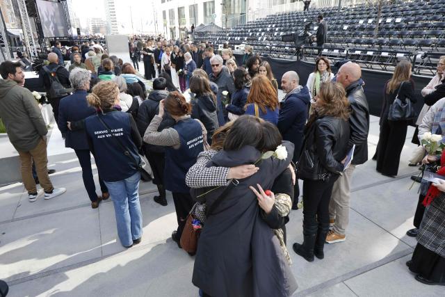 Attendees embrace during a commemoration ceremony for the March 2016 terror attacks at the memorial monument on Rue de la Loi (Wetstraat) in Brussels on March 22, 2026. Belgium is marking the tenth anniversary of the 2016 jihadist bombings in Brussels, a trauma that still scars the country and that authorities say sharpened focus on intelligence and counterterrorism. (Photo by NICOLAS MAETERLINCK / Belga / AFP) / Belgium OUT