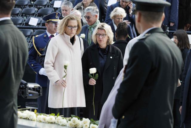 Attendees lay down flowers during a commemoration ceremony for the March 2016 terror attacks at the memorial monument on Rue de la Loi (Wetstraat) in Brussels on March 22, 2026. Belgium is marking the tenth anniversary of the 2016 jihadist bombings in Brussels, a trauma that still scars the country and that authorities say sharpened focus on intelligence and counterterrorism. (Photo by NICOLAS MAETERLINCK / Belga / AFP) / Belgium OUT