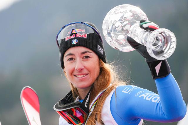 Overall winner Italy's Sofia Goggia celebrates with the Super-G overall trophy after the women's FIS Ski World Cup super-G event in Kvitfjell, near Lillehammer, Norway on March 22, 2026. (Photo by Cornelius Poppe / NTB / AFP) / Norway OUT