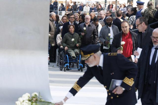 Attendees lay down flowers during a commemoration ceremony for the March 2016 terror attacks at the memorial monument on Rue de la Loi (Wetstraat) in Brussels on March 22, 2026. Belgium is marking the tenth anniversary of the 2016 jihadist bombings in Brussels, a trauma that still scars the country and that authorities say sharpened focus on intelligence and counterterrorism. (Photo by NICOLAS MAETERLINCK / Belga / AFP) / Belgium OUT