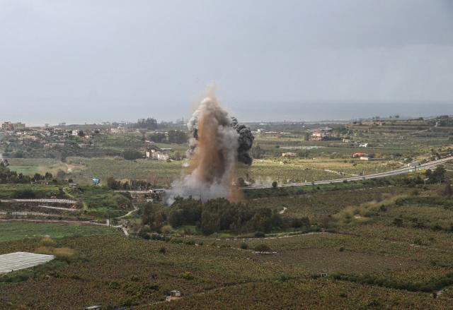 Smoke rises from the site of an Israeli airstrike that targeted the Qasmiyeh bridge, located on a main highway linking villages in the Tyre district with others further north, after Israel had said the bridge was being used by Hezbollah, in southern Lebanon on March 22, 2026. Israel's military struck a key bridge in south Lebanon on Sunday, an AFP correspondent said, after Israel's defence minister said the army had been ordered to destroy more bridges over the Litani River. Lebanon was drawn into the Middle East war on March 2, when pro-Iran Hezbollah launched rockets towards Israel in response to US-Israeli strikes that killed Iranian supreme leader on February 28, 2026. (Photo by Kawnat HAJU / AFP) / 