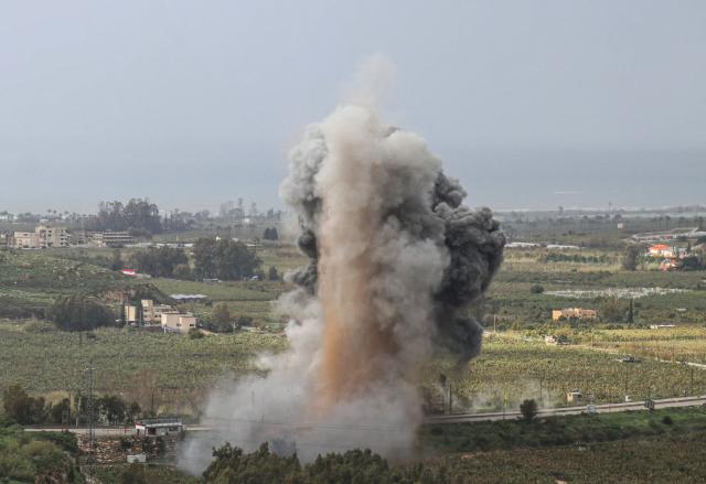 Smoke rises from the site of an Israeli airstrike that targeted the Qasmiyeh bridge, located on a main highway linking villages in the Tyre district with others further north, after Israel had said the bridge was being used by Hezbollah, in southern Lebanon on March 22, 2026. Israel's military struck a key bridge in south Lebanon on Sunday, an AFP correspondent said, after Israel's defence minister said the army had been ordered to destroy more bridges over the Litani River. Lebanon was drawn into the Middle East war on March 2, when pro-Iran Hezbollah launched rockets towards Israel in response to US-Israeli strikes that killed Iranian supreme leader on February 28, 2026. (Photo by Kawnat HAJU / AFP) / 