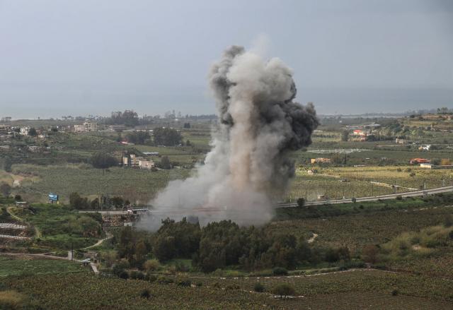 Smoke rises from the site of an Israeli airstrike that targeted the Qasmiyeh bridge, located on a main highway linking villages in the Tyre district with others further north, after Israel had said the bridge was being used by Hezbollah, in southern Lebanon on March 22, 2026. Israel's military struck a key bridge in south Lebanon on Sunday, an AFP correspondent said, after Israel's defence minister said the army had been ordered to destroy more bridges over the Litani River. Lebanon was drawn into the Middle East war on March 2, when pro-Iran Hezbollah launched rockets towards Israel in response to US-Israeli strikes that killed Iranian supreme leader on February 28, 2026. (Photo by Kawnat HAJU / AFP) / 