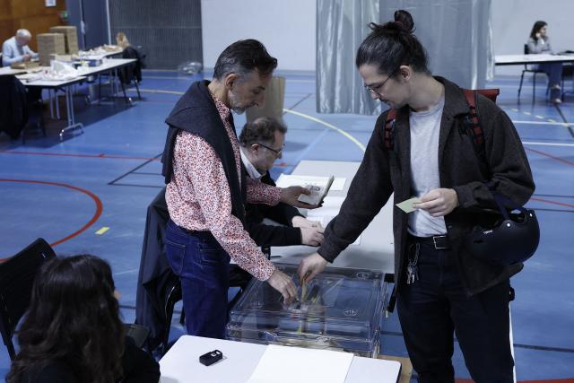 A citizen votes during the second round of France's 2026 municipal elections in Paris on March 22, 2026. (Photo by Kenzo TRIBOUILLARD / AFP)