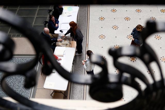 Citizens vote during the second round of France's 2026 municipal elections in Paris on March 22, 2026. (Photo by Kenzo TRIBOUILLARD / AFP)