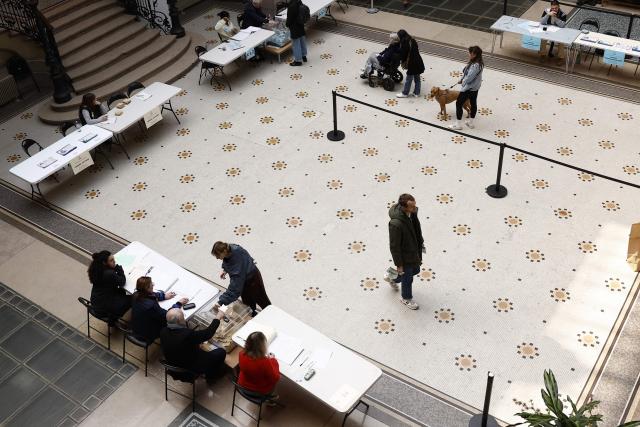 A citizen votes during the second round of France's 2026 municipal elections in Paris on March 22, 2026. (Photo by Kenzo TRIBOUILLARD / AFP)