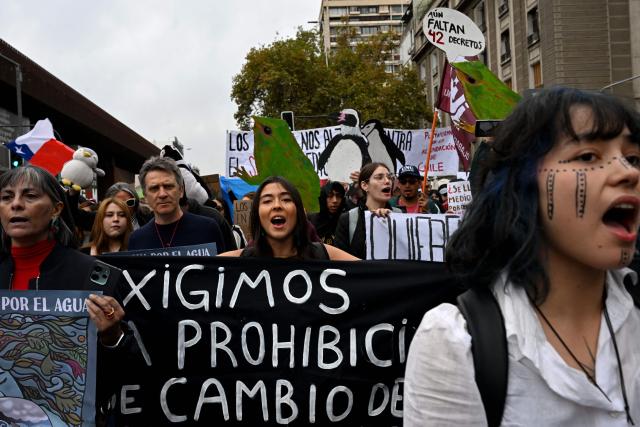 Protesters take part in a demonstration on World Water Day amid President Jose Antonio Kast's plans to roll back environmental protections in Santiago on March 22, 2026. (Photo by RODRIGO ARANGUA / AFP)