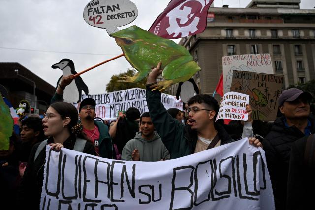 Protesters take part in a demonstration on World Water Day amid President Jose Antonio Kast's plans to roll back environmental protections in Santiago on March 22, 2026. (Photo by RODRIGO ARANGUA / AFP)