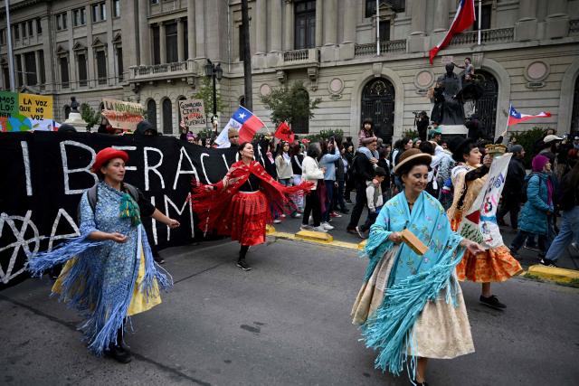 Dancers perform during a demonstration on World Water Day amid President Jose Antonio Kast's plans to roll back environmental protections in Santiago on March 22, 2026. (Photo by RODRIGO ARANGUA / AFP)