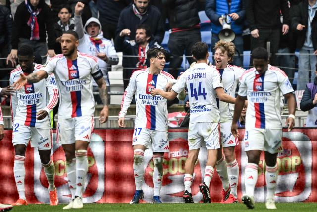 Lyon's Czech midfielder #10 Pavel Sulc (2R) celebrates with his teammates after scoring his team first goal during the French L1 football match between Olympique Lyonnais (OL) and AS Monaco at the Groupama Stadium in Decines-Charpieu, central-eastern France on March 22, 2026. (Photo by JEFF PACHOUD / AFP)