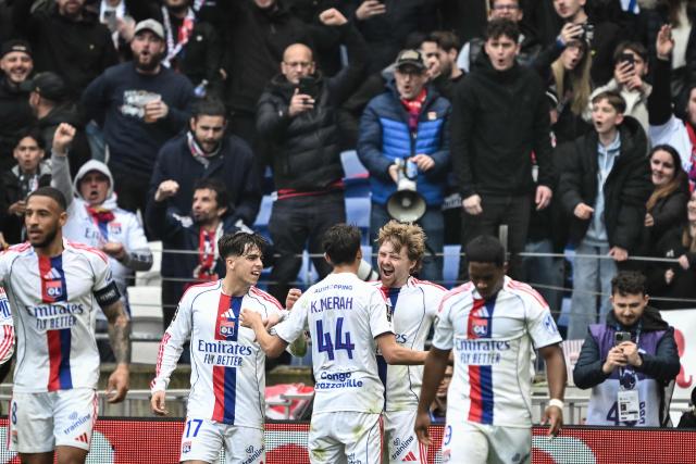 Lyon's Czech midfielder #10 Pavel Sulc (2R) celebrates with his teammates after scoring his team first goal during the French L1 football match between Olympique Lyonnais (OL) and AS Monaco at the Groupama Stadium in Decines-Charpieu, central-eastern France on March 22, 2026. (Photo by JEFF PACHOUD / AFP)