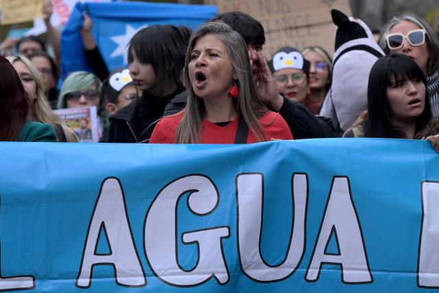 A protester shouts slogans during a demonstration on World Water Day amid President Jose Antonio Kast's plans to roll back environmental protections in Santiago on March 22, 2026. (Photo by Rodrigo ARANGUA / AFP)