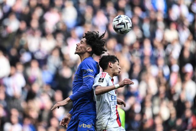 Lyon’s French midfielder #44 Khalis Merah (R) fights for the ball with Monaco’s French midfielder #11 Maghnes Akliouche (L) during the French L1 football match between Olympique Lyonnais (OL) and AS Monaco (ASM) at the Groupama Stadium in Decines-Charpieu, central-eastern France on March 22, 2026. (Photo by JEFF PACHOUD / AFP)