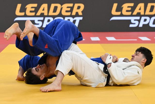 Georgia's Luka Javakhishvili (white) competes against Georgia's Akaki Japaridze in the men's under 90 kg bronze medal bout at the Tbilisi Grand Slam judo tournament in Tbilisi on March 22, 2026. (Photo by Vano SHLAMOV / AFP)