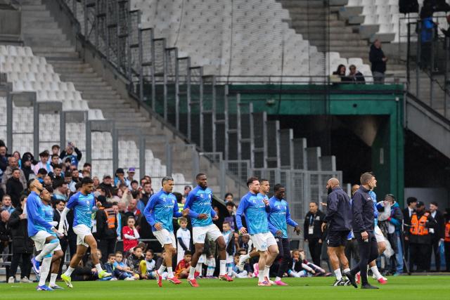 Marseille's players warm up ahead of the French L1 football match between Olympique de Marseille (OM) and Lille OSC at the Stade Velodrome in Marseille, southern France on March 22, 2026. (Photo by Pascal POCHARD-CASABIANCA / AFP)