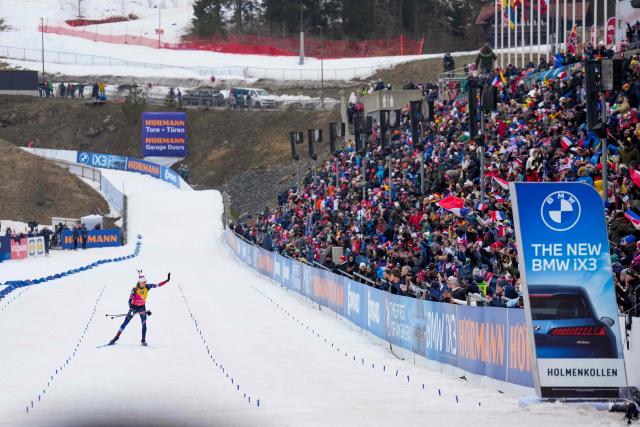 Third place France's Eric Perrot celebrates at the finnish of the men's 15km mass start event of the IBU Biathlon World Cup in Holmenkollen, Oslo on March 22, 2026. (Photo by Heiko Junge / NTB / AFP) / Norway OUT