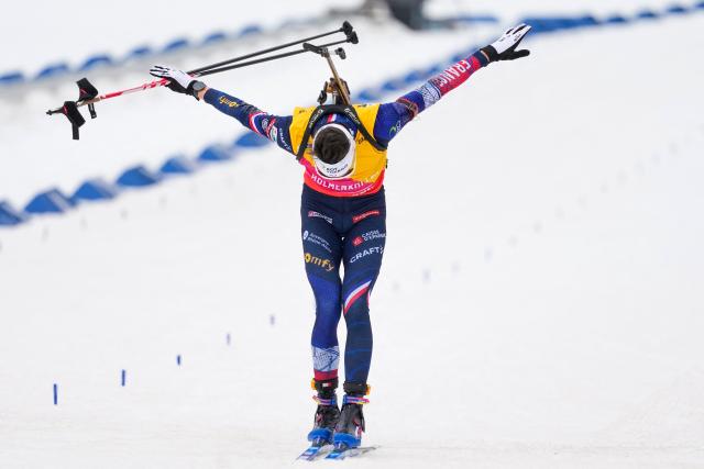 Third place France's Eric Perrot celebrates at the finnish of the men's 15km mass start event of the IBU Biathlon World Cup in Holmenkollen, Oslo on March 22, 2026. (Photo by Heiko Junge / NTB / AFP) / Norway OUT