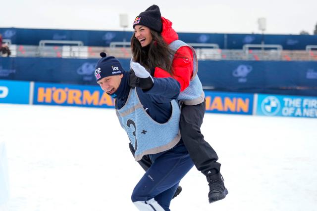 Norway's Vetle Sjaastad Christiansen and Italy's Lisa Vittozzi celebrate after the men's 15km mass start event of the IBU Biathlon World Cup in Holmenkollen, Oslo on March 22, 2026. (Photo by Heiko Junge / NTB / AFP) / Norway OUT