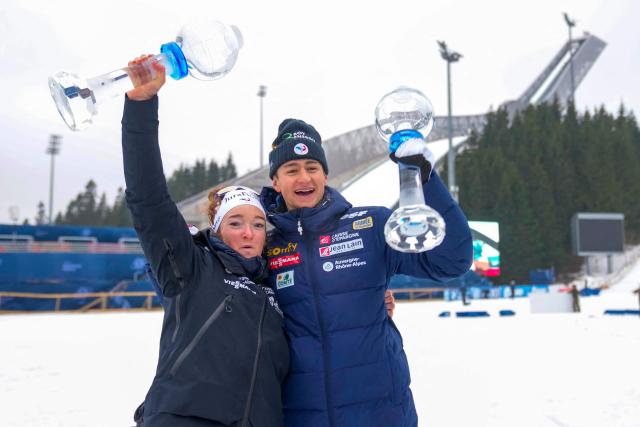 France's Lou Jeanmonnot and France's Eric Perrot celebrate with the crystal trophies after the IBU Biathlon World Cup in Holmenkollen, Oslo on March 22, 2026. (Photo by Heiko Junge / NTB / AFP) / Norway OUT