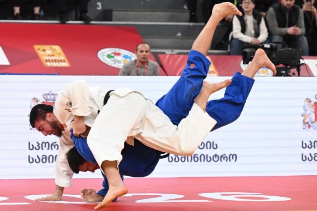 Russia's Idar Bifov (white) competes against Russia's Niiaz Bilalov in the men's under 100 kg final bout at the Tbilisi Grand Slam judo tournament in Tbilisi on March 22, 2026. (Photo by Vano SHLAMOV / AFP)