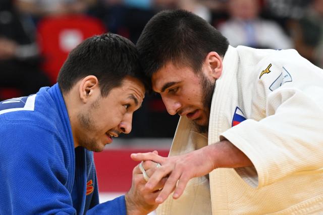 Russia's Idar Bifov (white) competes against Russia's Niiaz Bilalov in the men's under 100 kg final bout at the Tbilisi Grand Slam judo tournament in Tbilisi on March 22, 2026. (Photo by Vano SHLAMOV / AFP)