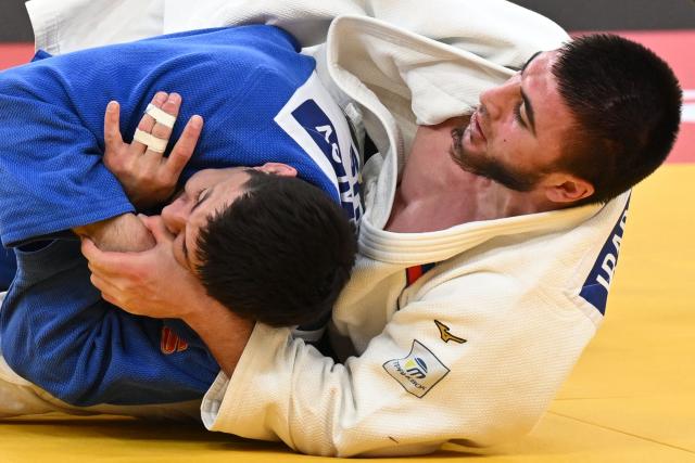 Russia's Idar Bifov (white) competes against Russia's Niiaz Bilalov in the men's under 100 kg final bout at the Tbilisi Grand Slam judo tournament in Tbilisi on March 22, 2026. (Photo by Vano SHLAMOV / AFP)
