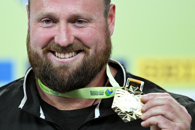Gold medallist New Zealand's Tom Walsh celebrates on the podium after the men's final shot put event during the World Athletics Indoor Championships Kujawy Pomorze 2026 in Torun, Poland on March 22, 2026. (Photo by Kirill KUDRYAVTSEV / AFP)