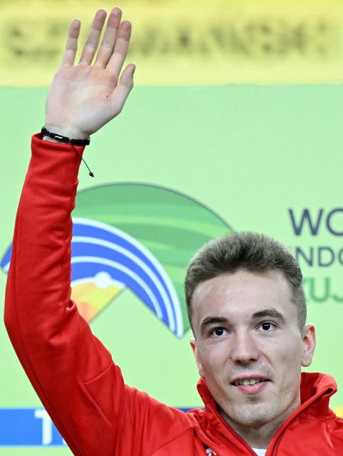 Gold medallist Poland's Jakub Szymanski celebrates on the podium for the men's 60m hurdles event during the World Athletics Indoor Championships Kujawy Pomorze 2026 in Torun, Poland on March 22, 2026. (Photo by Kirill KUDRYAVTSEV / AFP)