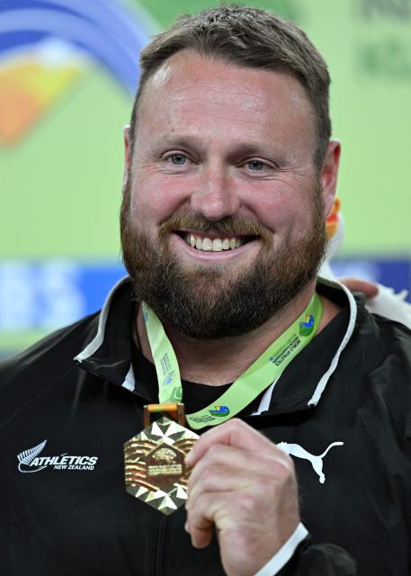 Gold medallist New Zealand's Tom Walsh celebrates on the podium after the men's final shot put event during the World Athletics Indoor Championships Kujawy Pomorze 2026 in Torun, Poland on March 22, 2026. (Photo by Kirill KUDRYAVTSEV / AFP)
