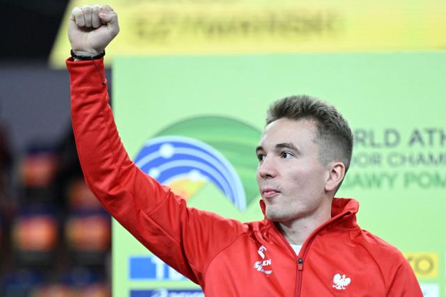 Gold medallist Poland's Jakub Szymanski celebrates on the podium for the men's 60m hurdles event during the World Athletics Indoor Championships Kujawy Pomorze 2026 in Torun, Poland on March 22, 2026. (Photo by Kirill KUDRYAVTSEV / AFP)