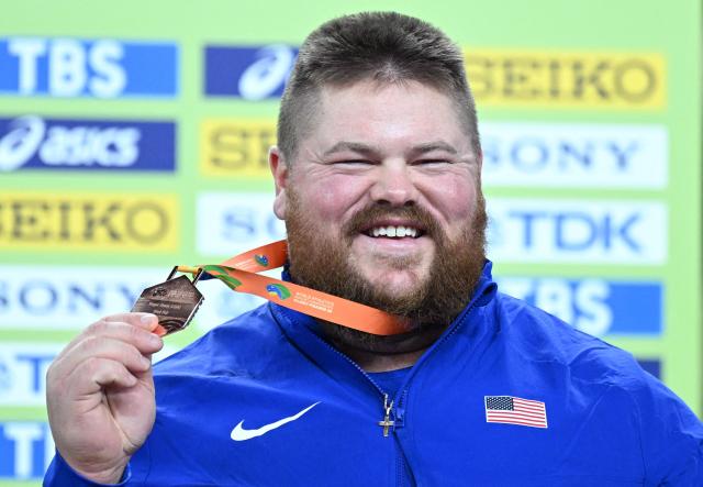 Bronze medallist USA's Roger Steen celebrates on the podium after the men's final shot put event during the World Athletics Indoor Championships Kujawy Pomorze 2026 in Torun, Poland on March 22, 2026. (Photo by Kirill KUDRYAVTSEV / AFP)