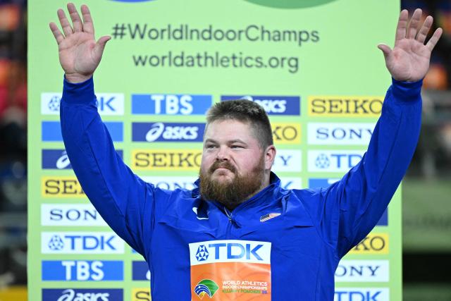 Bronze medallist USA's Roger Steen celebrates on the podium after the men's final shot put event during the World Athletics Indoor Championships Kujawy Pomorze 2026 in Torun, Poland on March 22, 2026. (Photo by Kirill KUDRYAVTSEV / AFP)
