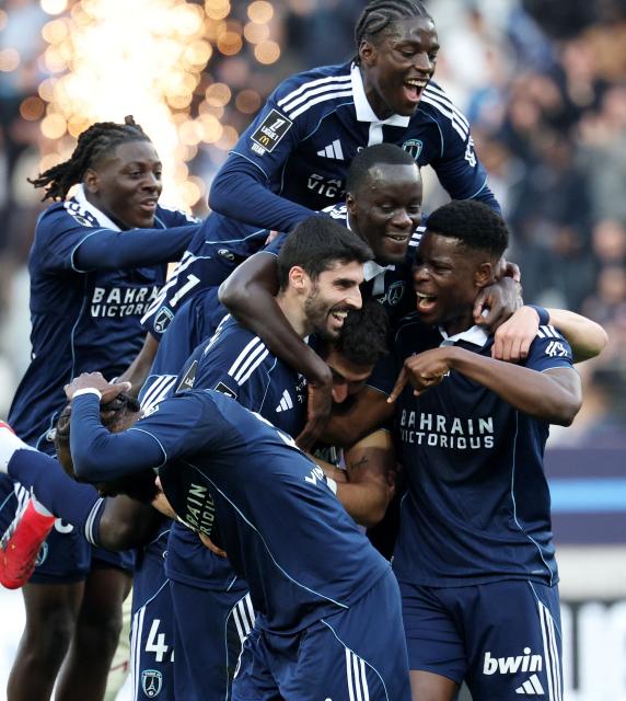 Paris FC's French milfielder #33 Pierre Less Melou (C-L) celebrates with teammates after Le Havre scores an own goal during the French L1 football match between Paris FC and Le Havre AC at the Stade Jean-Bouin in Paris on March 22, 2026. (Photo by FRANCK FIFE / AFP)