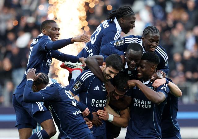 Paris FC's French milfielder #33 Pierre Less Melou (C-L) celebrates with teammates after Le Havre scores an own goal during the French L1 football match between Paris FC and Le Havre AC at the Stade Jean-Bouin in Paris on March 22, 2026. (Photo by FRANCK FIFE / AFP)