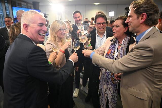 Members of the conservative Christian Democratic Union (CDU) party react on March 22, 2026 at the regional parliament in Mainz, southwestern Germany, as first exit polls of Rhineland-Palatinate's state elections are being released. German Chancellor Friedrich Merz's conservative CDU party ousted the centre-left Social Democratic Party on Sunday in a closely watched state election in which the far right also made big gains, according to exit polls. The CDU took around 30 percent of the vote to win the western state of Rhineland-Palatinate away from the SPD after 35 years, while the far-right Alternative for Germany party (AfD) looked set for a record score in western Germany, with around 20 percent, according to two public TV networks' exit polls. (Photo by DANIEL PETER / AFP)
