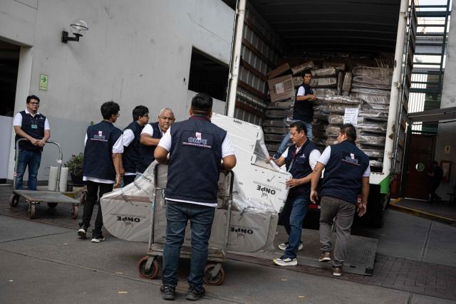 Workers from the ONPE (National Office of Electoral Processes) unload electoral material at the Ministry of Foreign Affairs, to then be sent to voters living abroad, in Lima on March 22, 2026. Peru will hold presidential elections on April 12, 2026. (Photo by ERNESTO BENAVIDES / AFP)