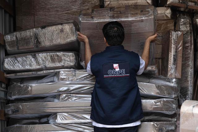 Workers from the ONPE (National Office of Electoral Processes) unload electoral material at the Ministry of Foreign Affairs, to then be sent to voters living abroad, in Lima on March 22, 2026. Peru will hold presidential elections on April 12, 2026. (Photo by ERNESTO BENAVIDES / AFP)