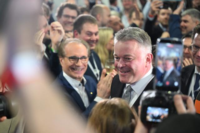 The conservative CDU party's top candidate for state elections in Rhineland-Palatinate Gordon Schnieder (C) is surrounded by supporters on March 22, 2026 at the regional parliament in Mainz, southwestern Germany, as first exit polls of Rhineland-Palatinate's state elections are being released. German Chancellor Friedrich Merz's conservative CDU party ousted the centre-left Social Democratic Party on Sunday in a closely watched state election in which the far right also made big gains, according to exit polls. The CDU took around 30 percent of the vote to win the western state of Rhineland-Palatinate away from the SPD after 35 years, while the far-right Alternative for Germany party (AfD) looked set for a record score in western Germany, with around 20 percent, according to two public TV networks' exit polls. (Photo by DANIEL PETER / AFP)