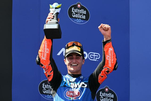 Italtrans Racing Team's Spanish rider Daniel Munoz, who finished second, celebrates on the podium of the Moto2 Grand Prix of Brazil at the Ayrton Senna International racetrack in Goiania, state of Goias, Brazil, on March 22, 2026. (Photo by EVARISTO SA / AFP)