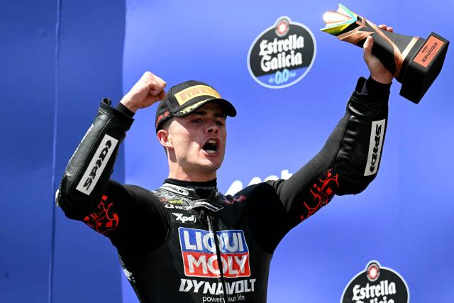 Liqui Moly Dynavolt Intact GP's Spanish rider Manuel Gonzalez, who finished third, celebrates on the podium of the Moto2 Grand Prix of Brazil at the Ayrton Senna International racetrack in Goiania, state of Goias, Brazil, on March 22, 2026. (Photo by EVARISTO SA / AFP)