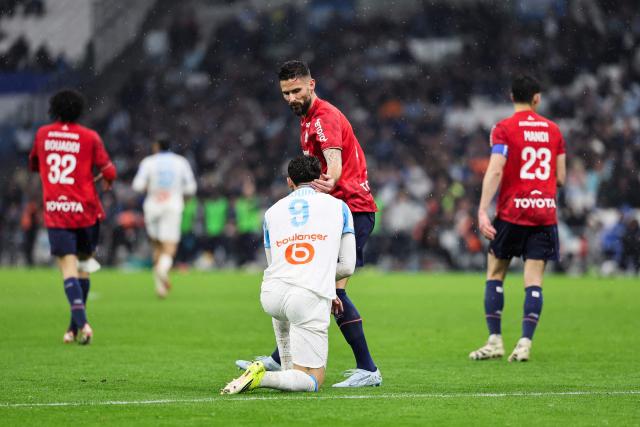 Lille's French forward #09 Olivier Giroud (C-R) gestures towards Marseille's Algerian forward #09 Amine Gouiri during the French L1 football match between Olympique de Marseille (OM) and Lille OSC at the Stade Velodrome in Marseille, southern France on March 22, 2026. (Photo by Pascal POCHARD-CASABIANCA / AFP)