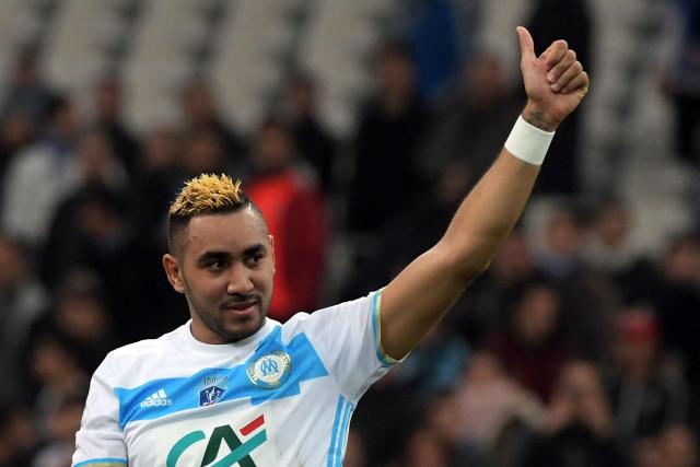 (FILES) Olympique de Marseille's French forward Dimitri Payet celebrates at the end of the French Cup football match between Marseille and Lyon, on January 31, 2017 at the Velodrome stadium in Marseille, southern France. Former Olympique de Marseille and France attacking midfielder Dimitri Payet announced the end of his career on March 22, 2026, during a Ligue 1+ interview at halftime of the match between OM and Lille for the 27th round of Ligue 1. (Photo by ANNE-CHRISTINE POUJOULAT / AFP)